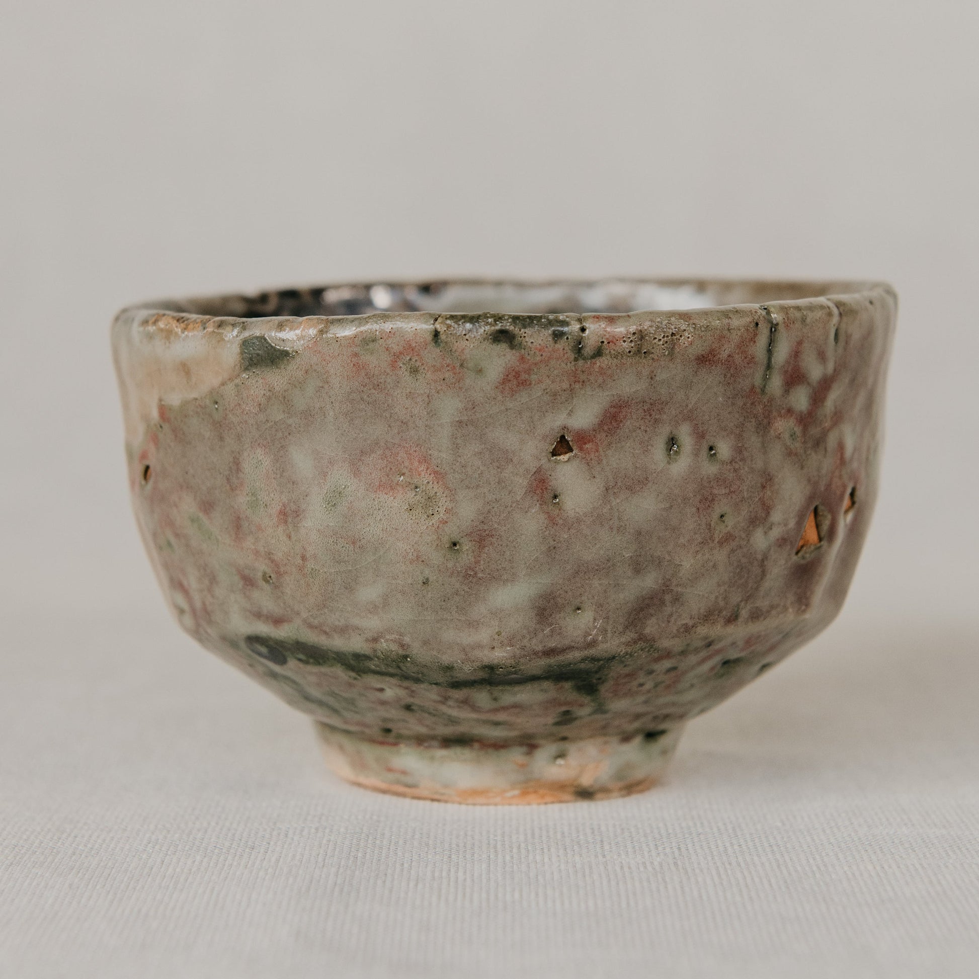 Small ceramic bowl with a textured surface on a light gray background