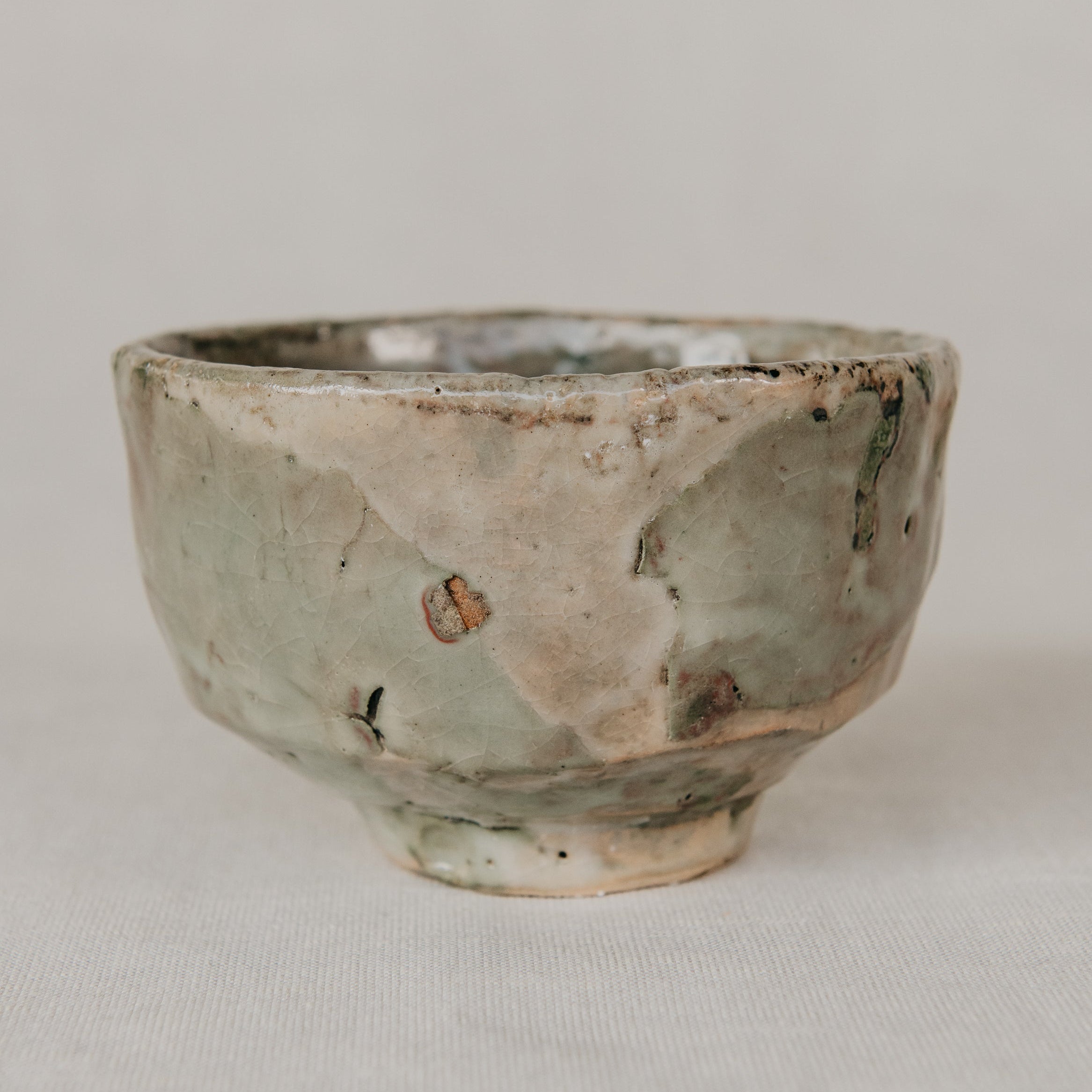 Small ceramic bowl with a textured surface on a plain background