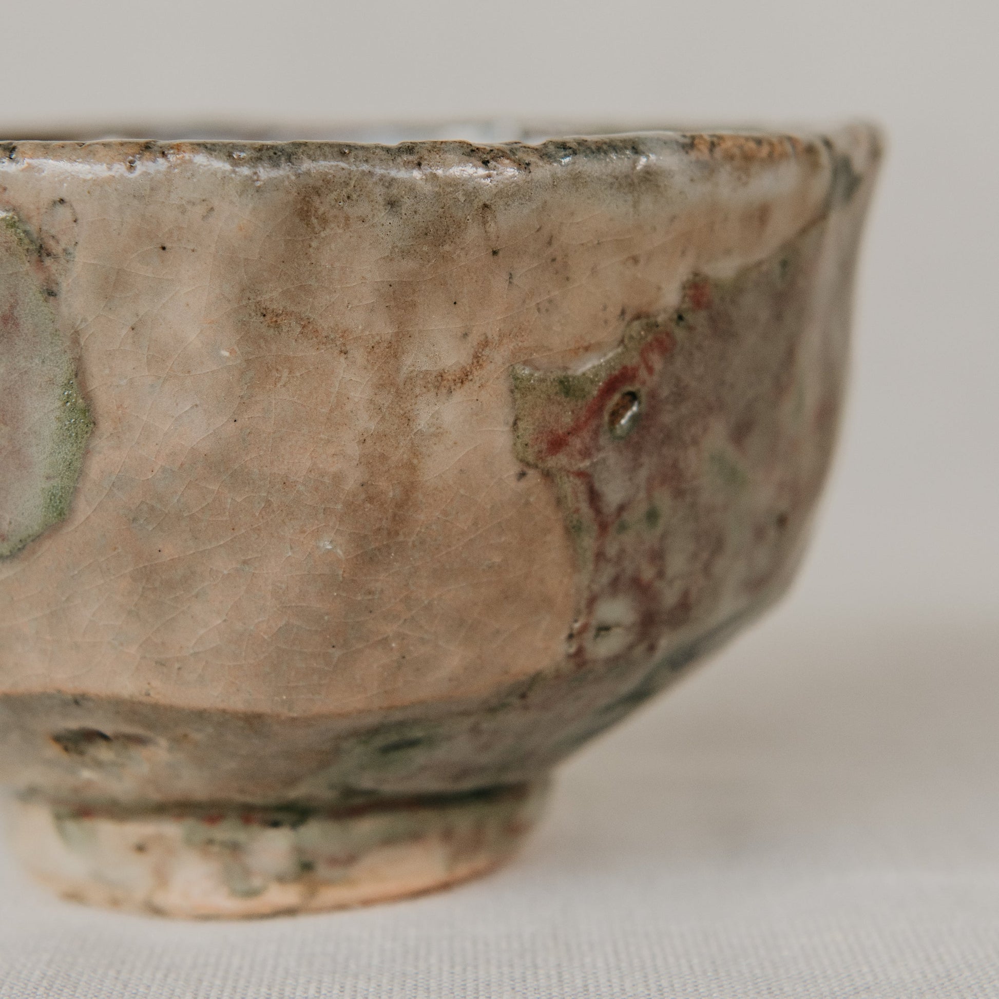 Close-up of a ceramic bowl with a textured surface on a light background