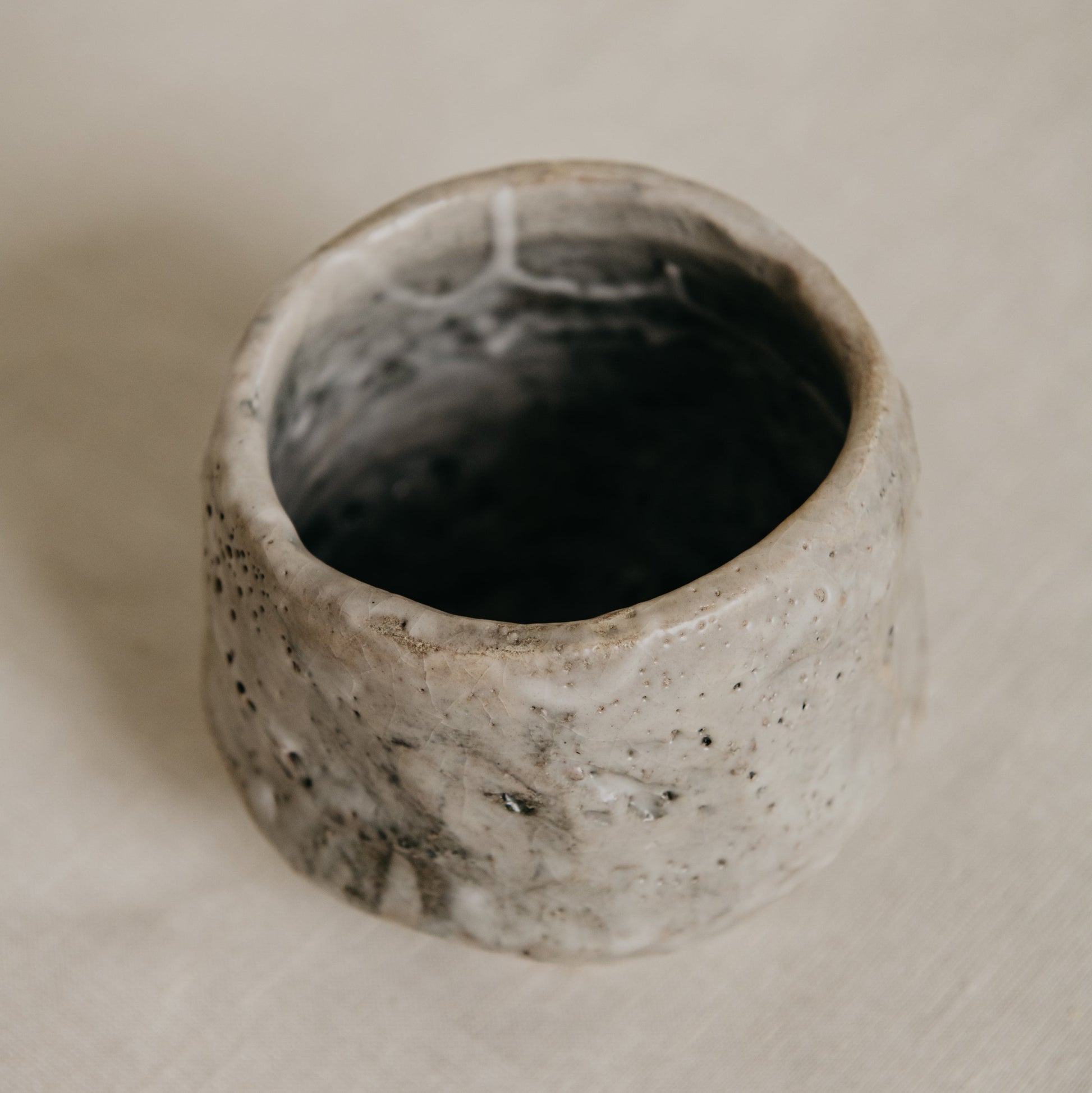 Ceramic bowl with textured surface on a beige background