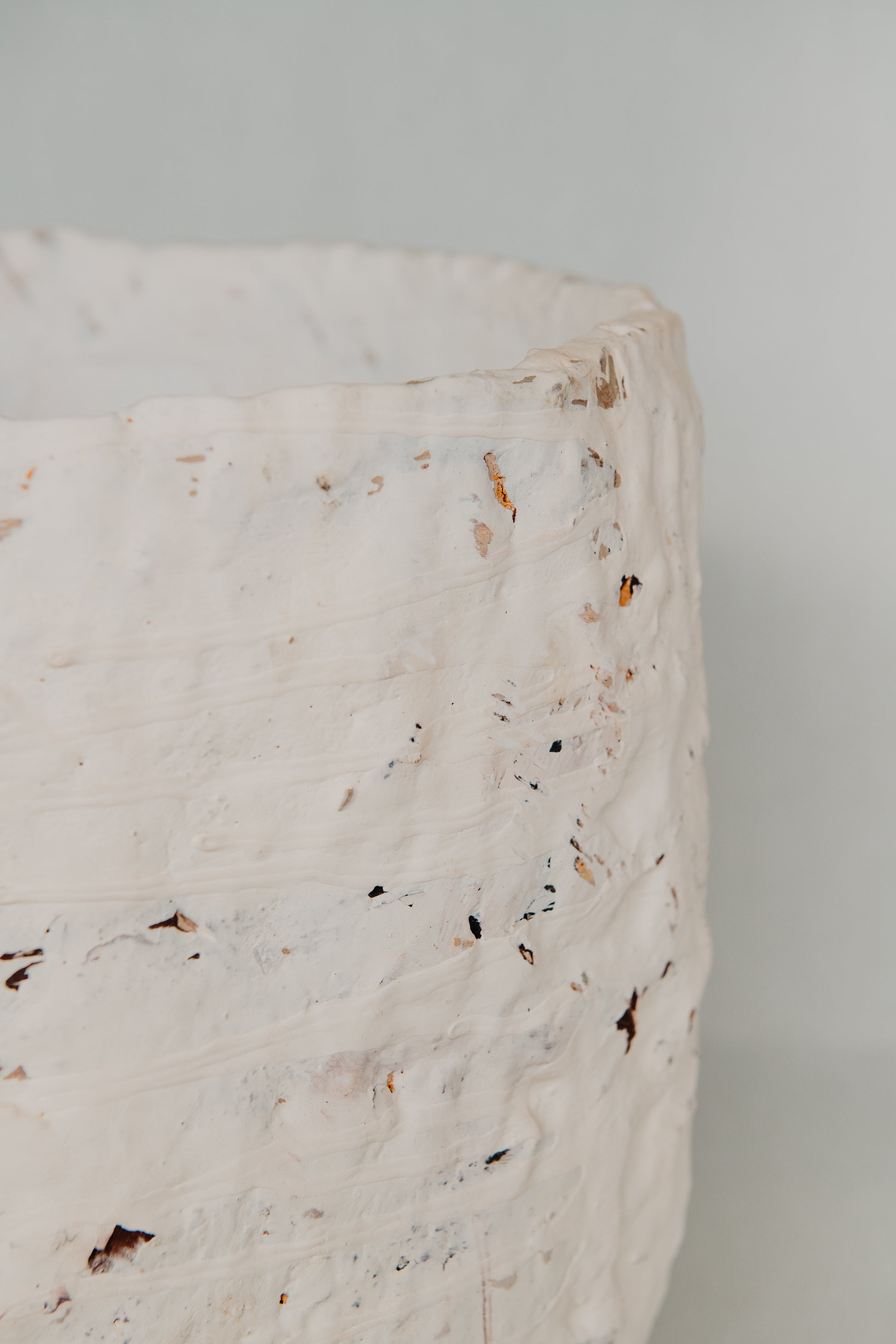 Close-up of a marble surface with speckled pattern on a light gray background