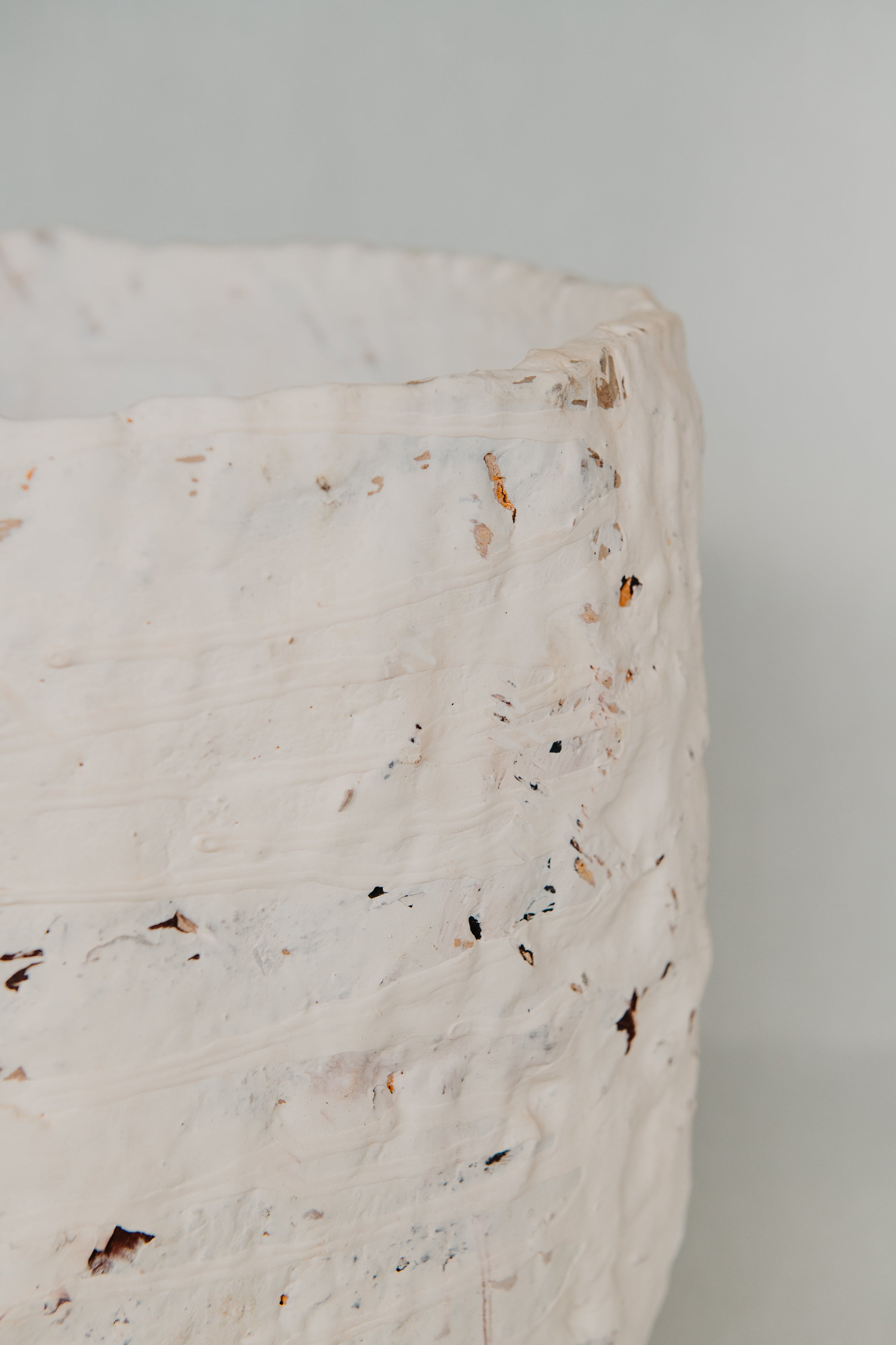Close-up of a marble surface with speckled pattern on a light gray background