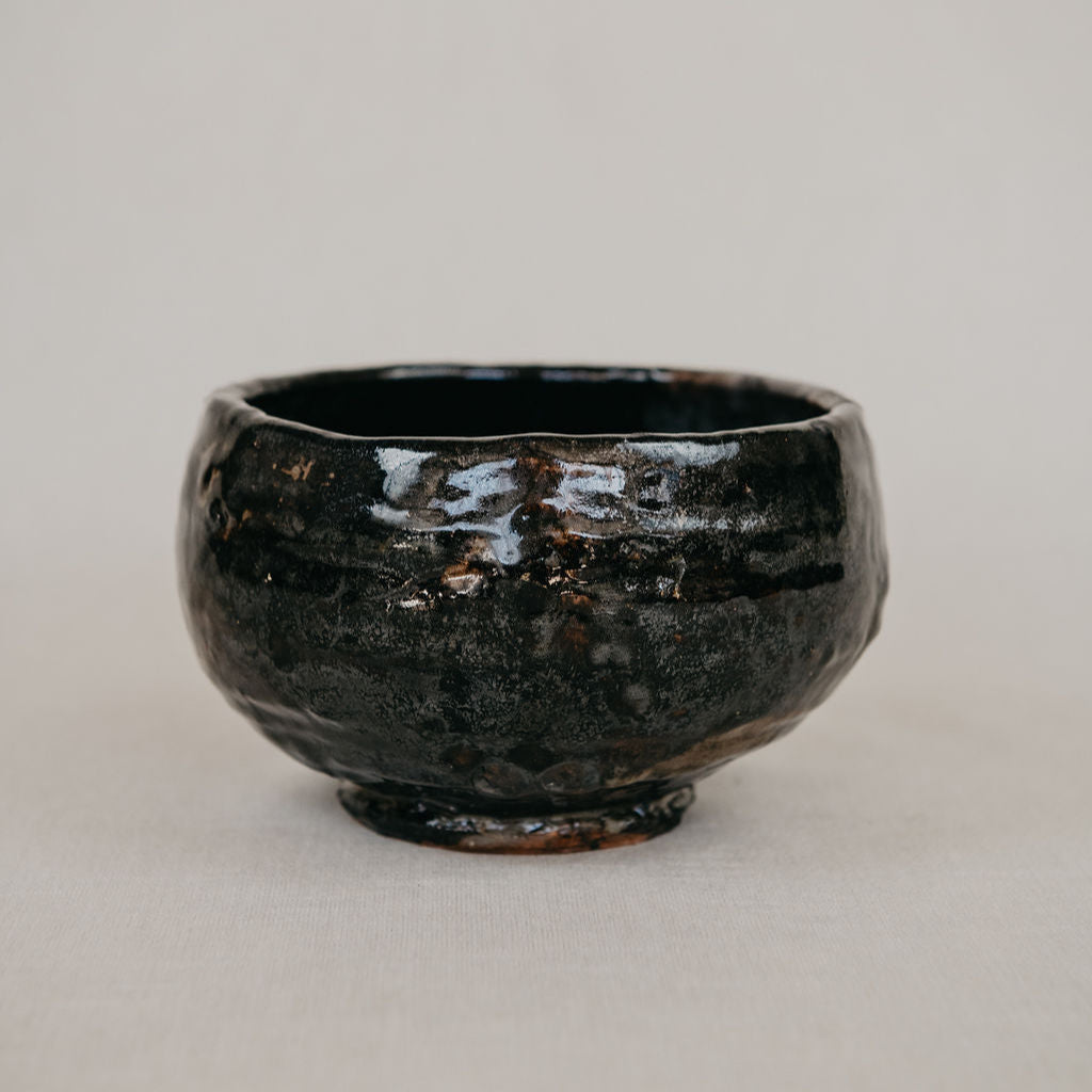 Black ceramic bowl on a light gray background