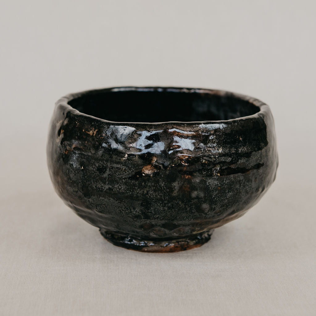 Black ceramic bowl on a light gray background