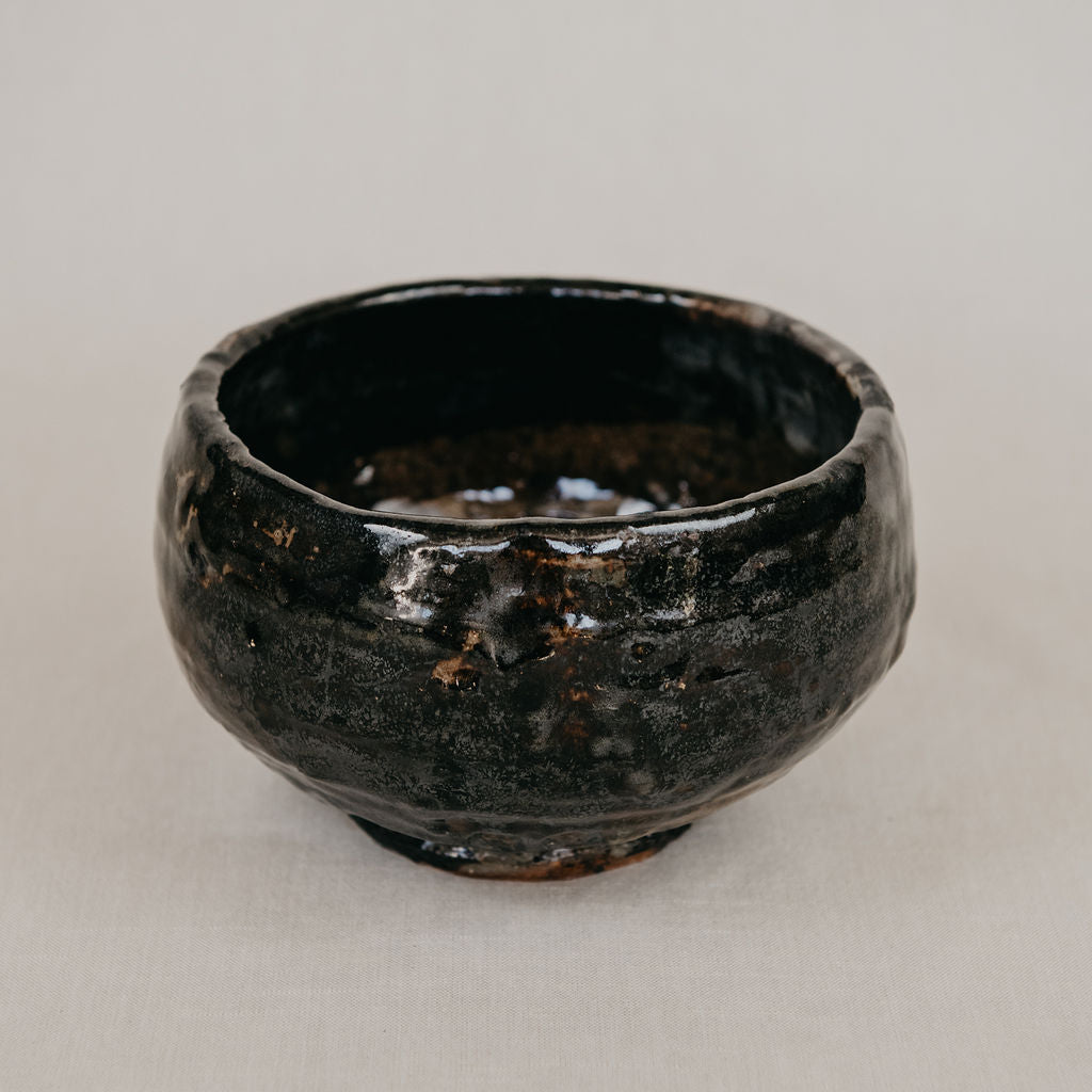 Black ceramic bowl on a light gray background