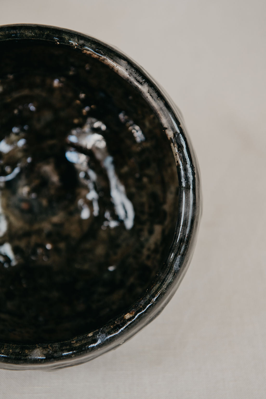 Close-up of a black ceramic bowl on a light background