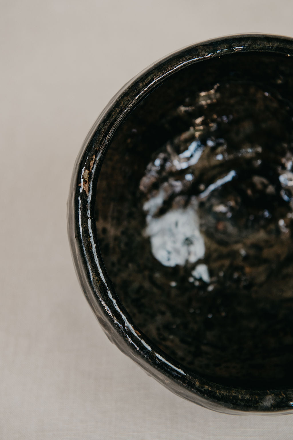 Close-up of a black ceramic bowl on a light background