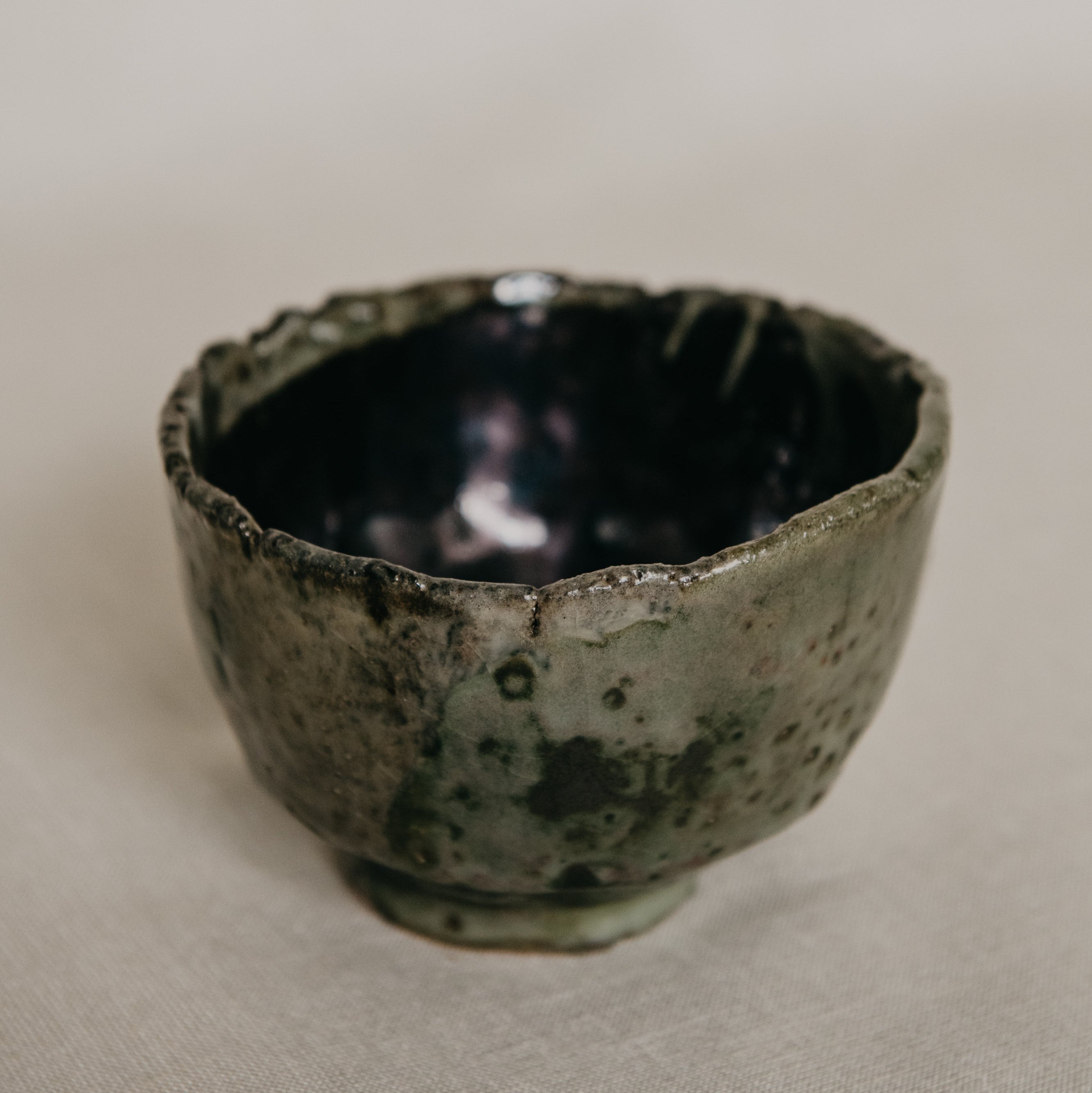 Ceramic bowl with textured surface on a neutral background