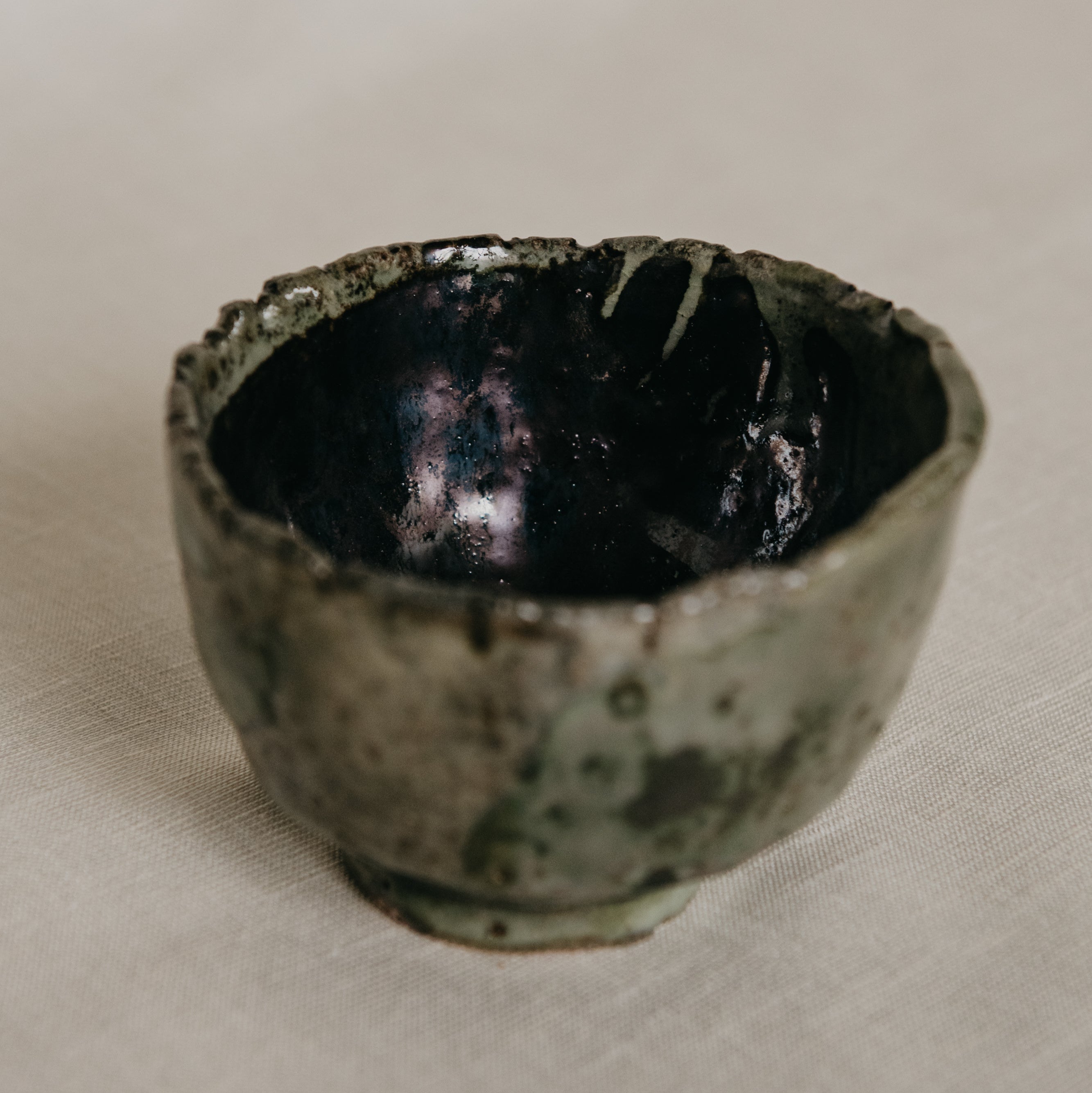 Ceramic cup with textured surface on a plain background