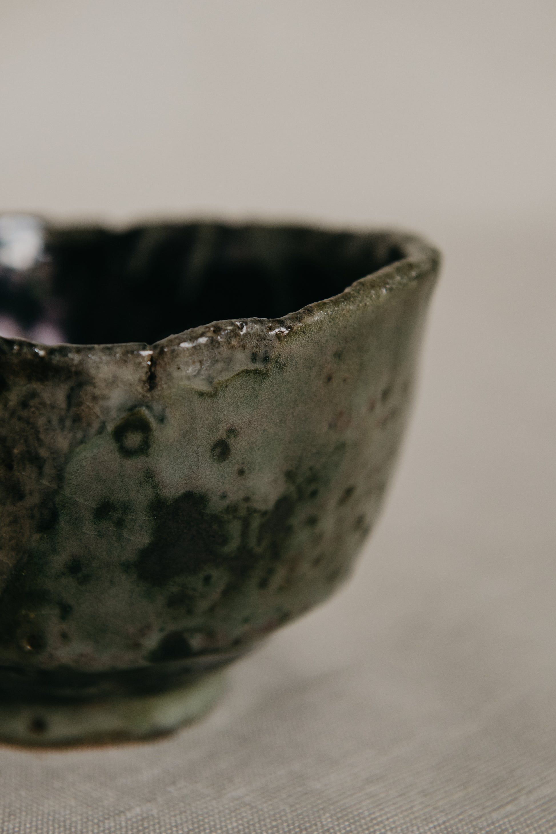 Close-up of a textured ceramic bowl on a neutral background