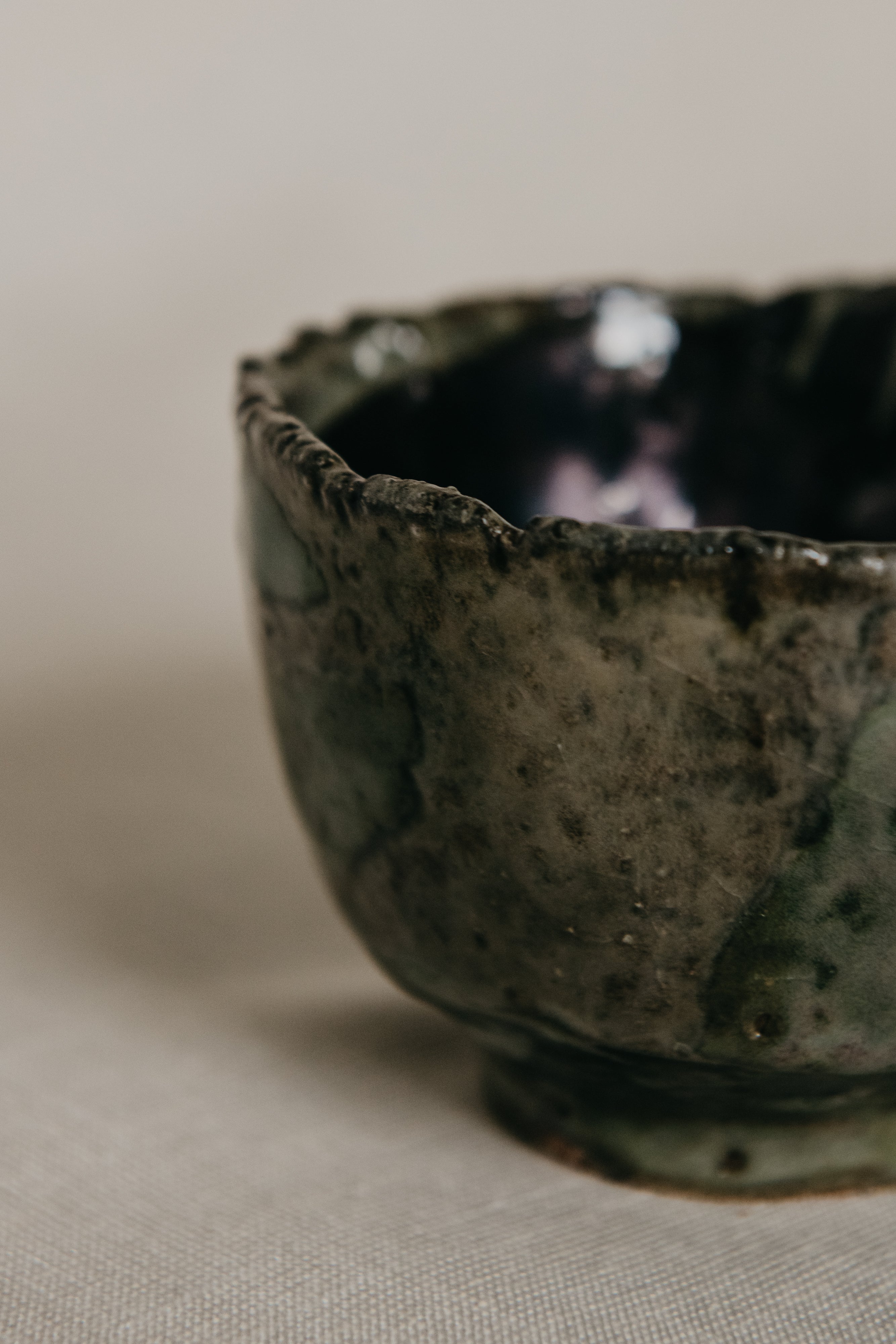Close-up of a ceramic bowl with textured surface on a neutral background