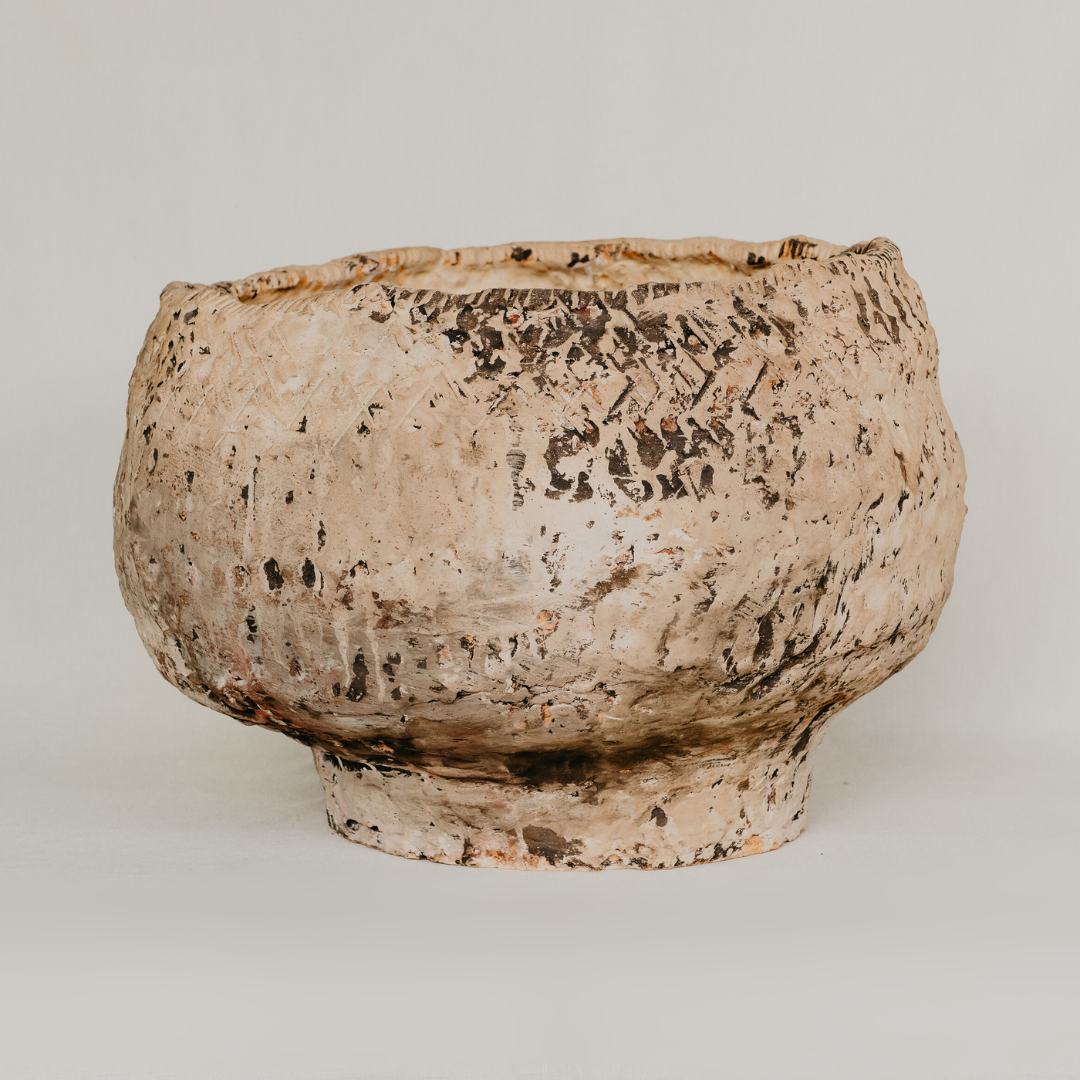 Ceramic bowl with textured surface on a plain background