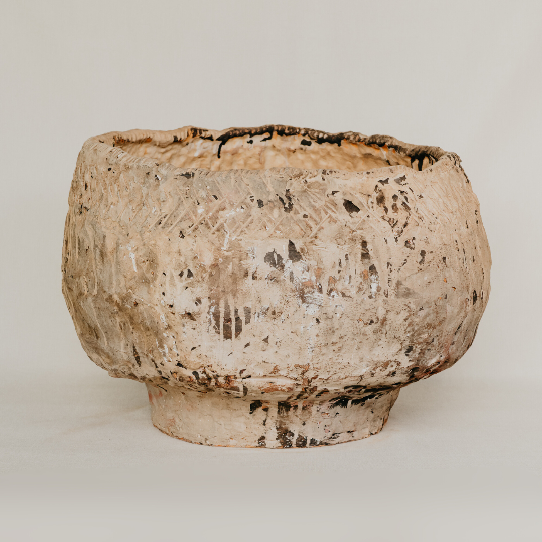 Textured ceramic bowl on a plain background