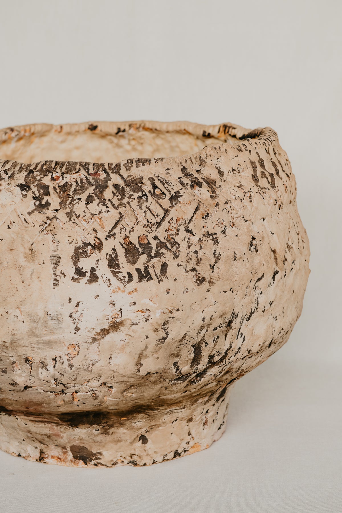 Textured ceramic bowl on a plain background