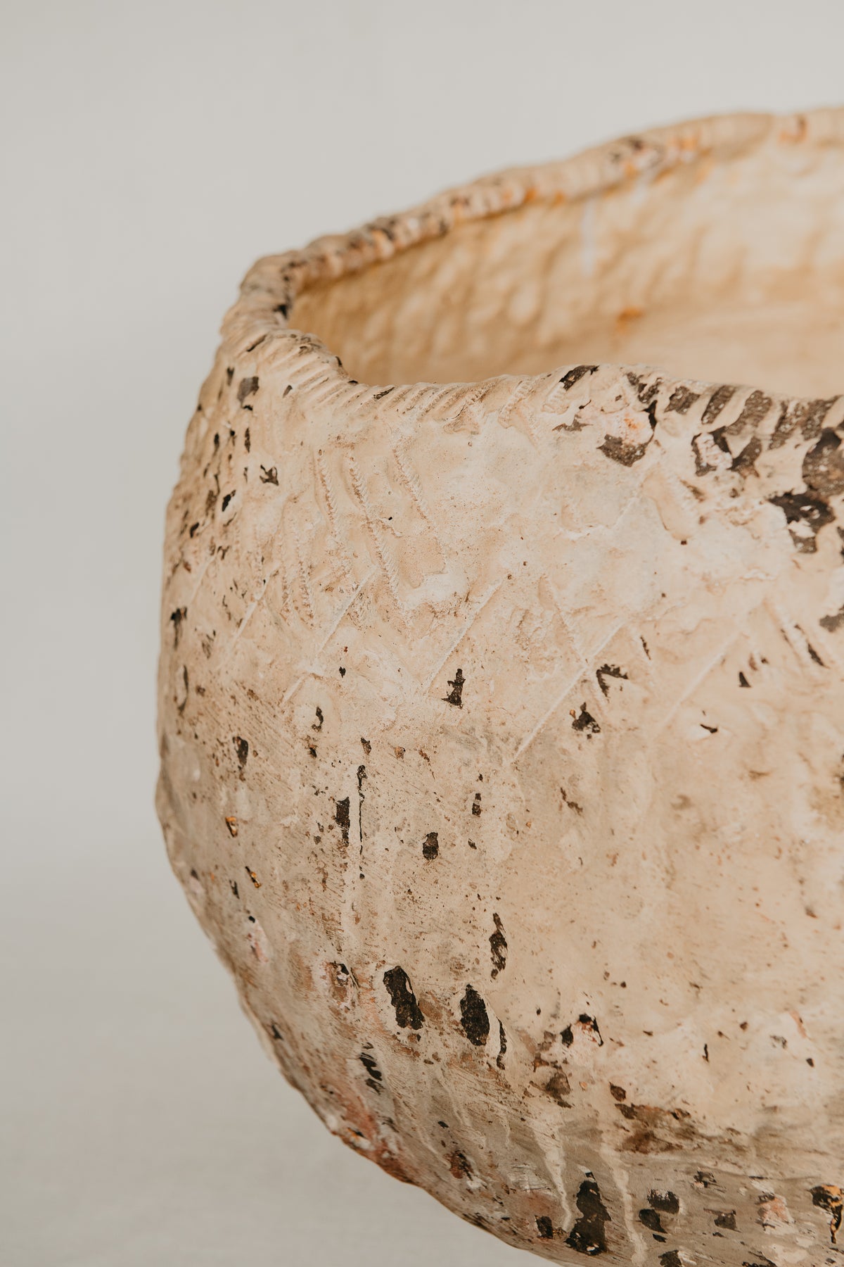 Close-up of a textured ceramic bowl on a plain background