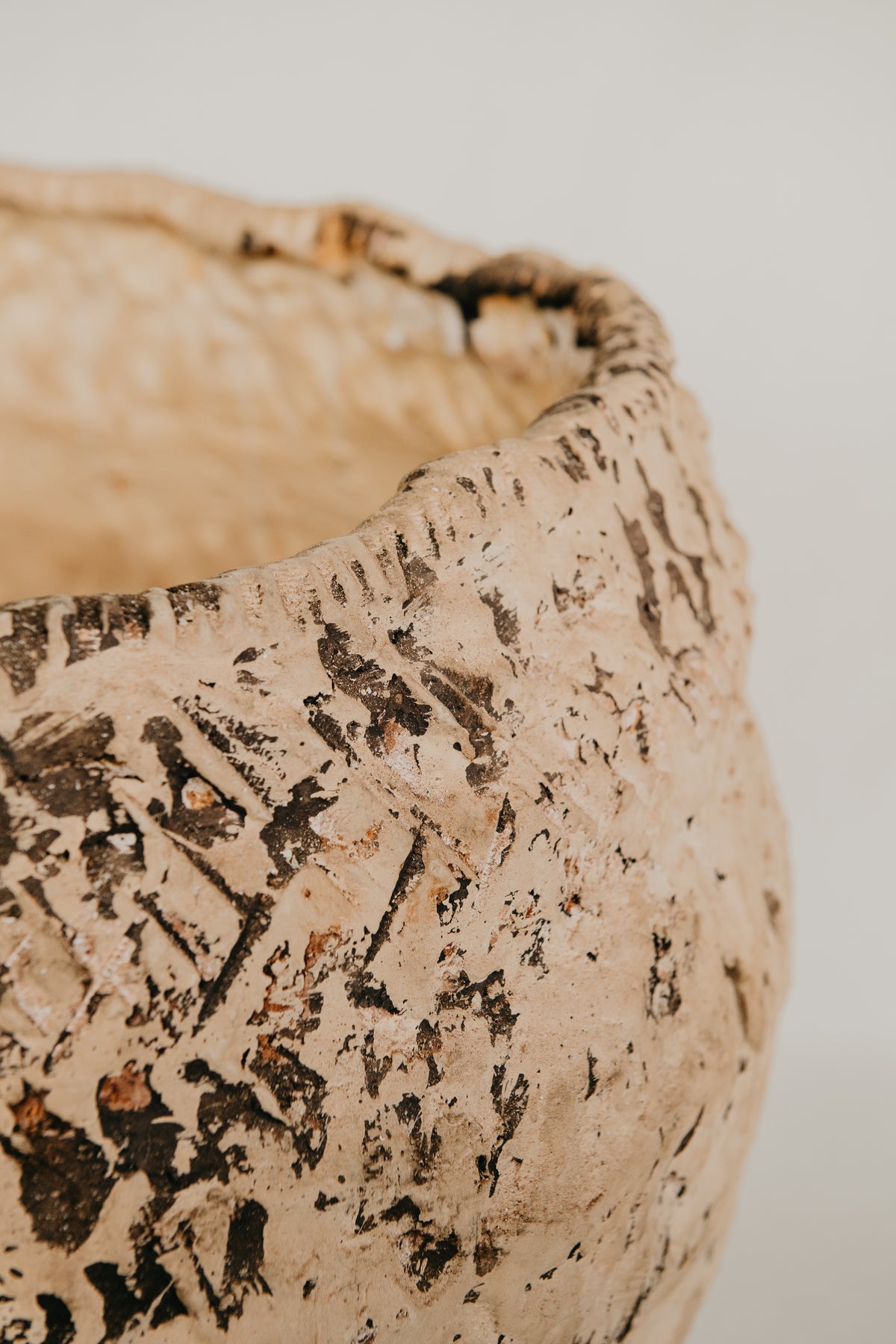 Close-up of a textured ceramic bowl on a plain background