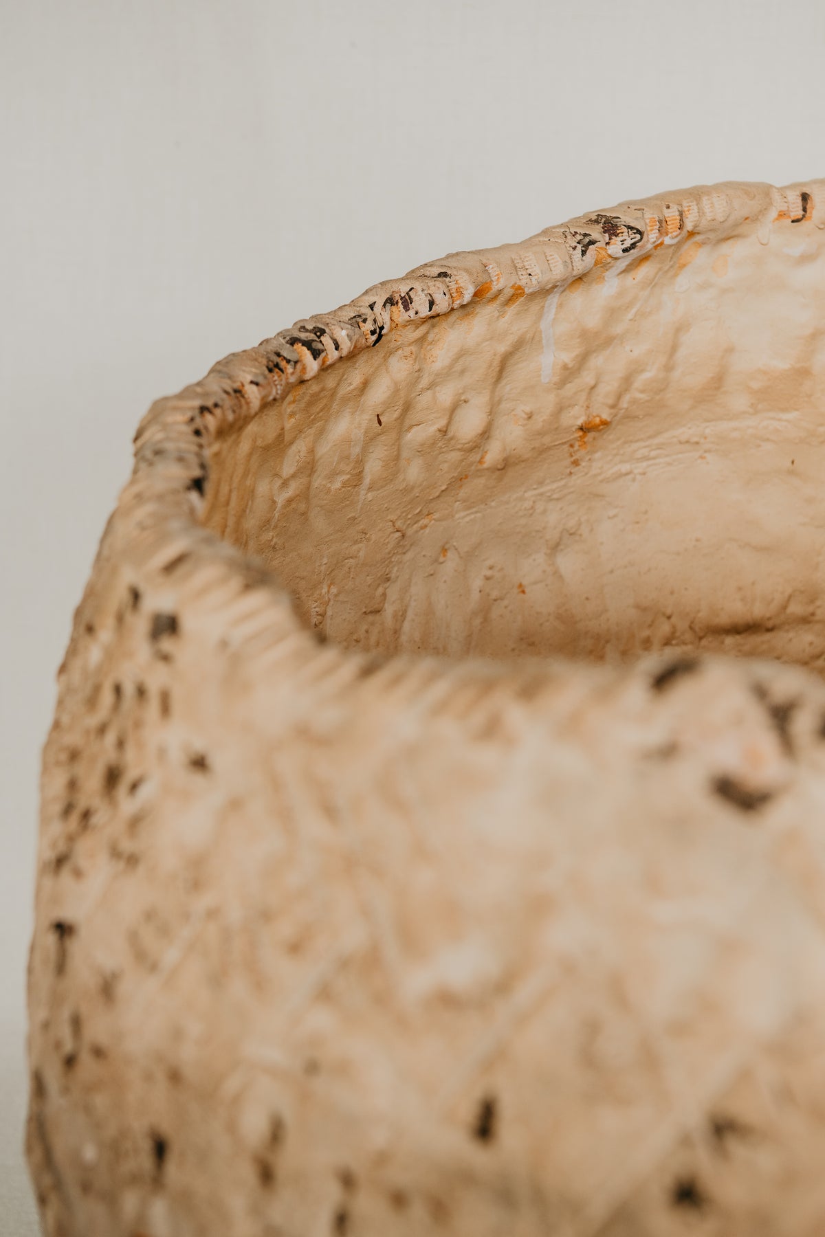 Close-up of a textured beige surface with a white background