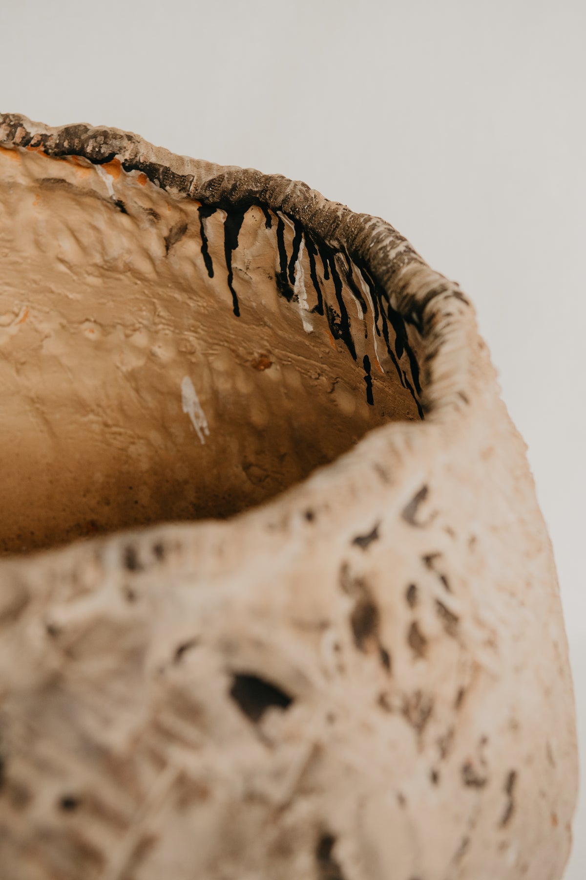 Close-up of a textured ceramic bowl with a white background