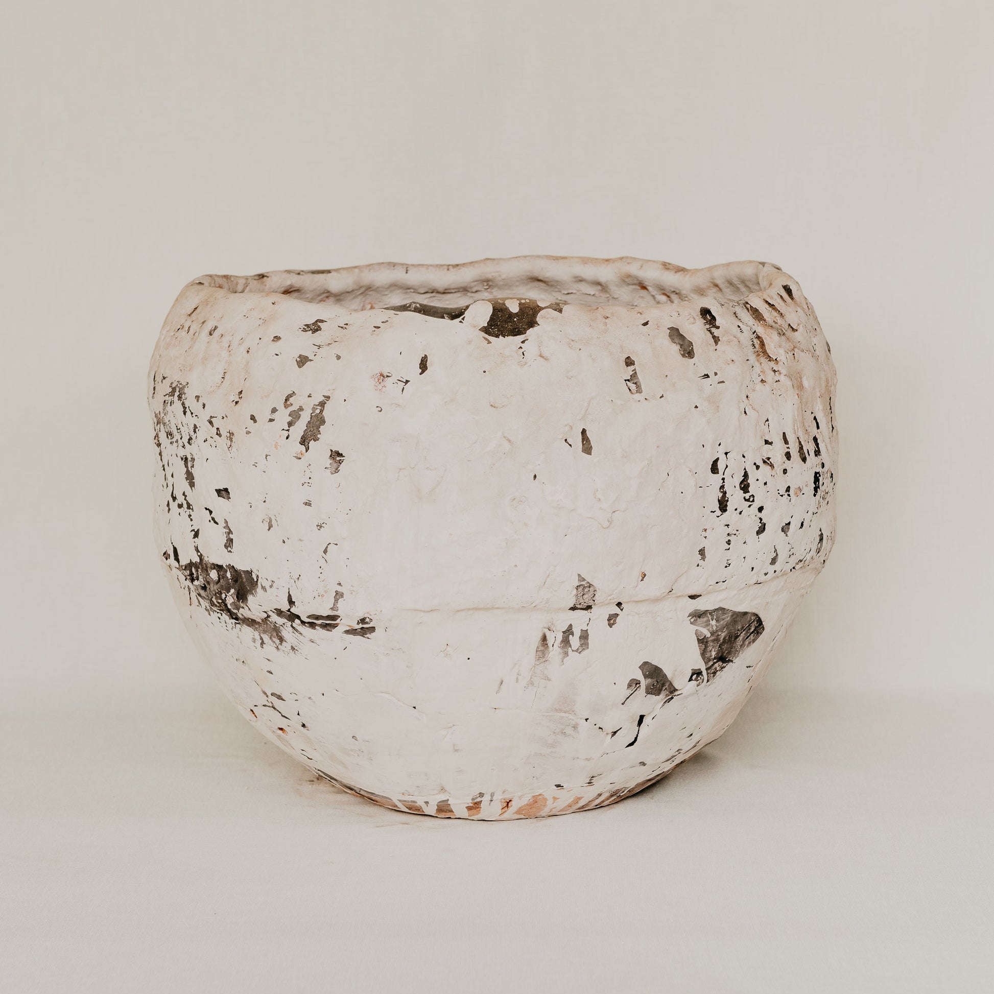 Textured ceramic pot on a white background