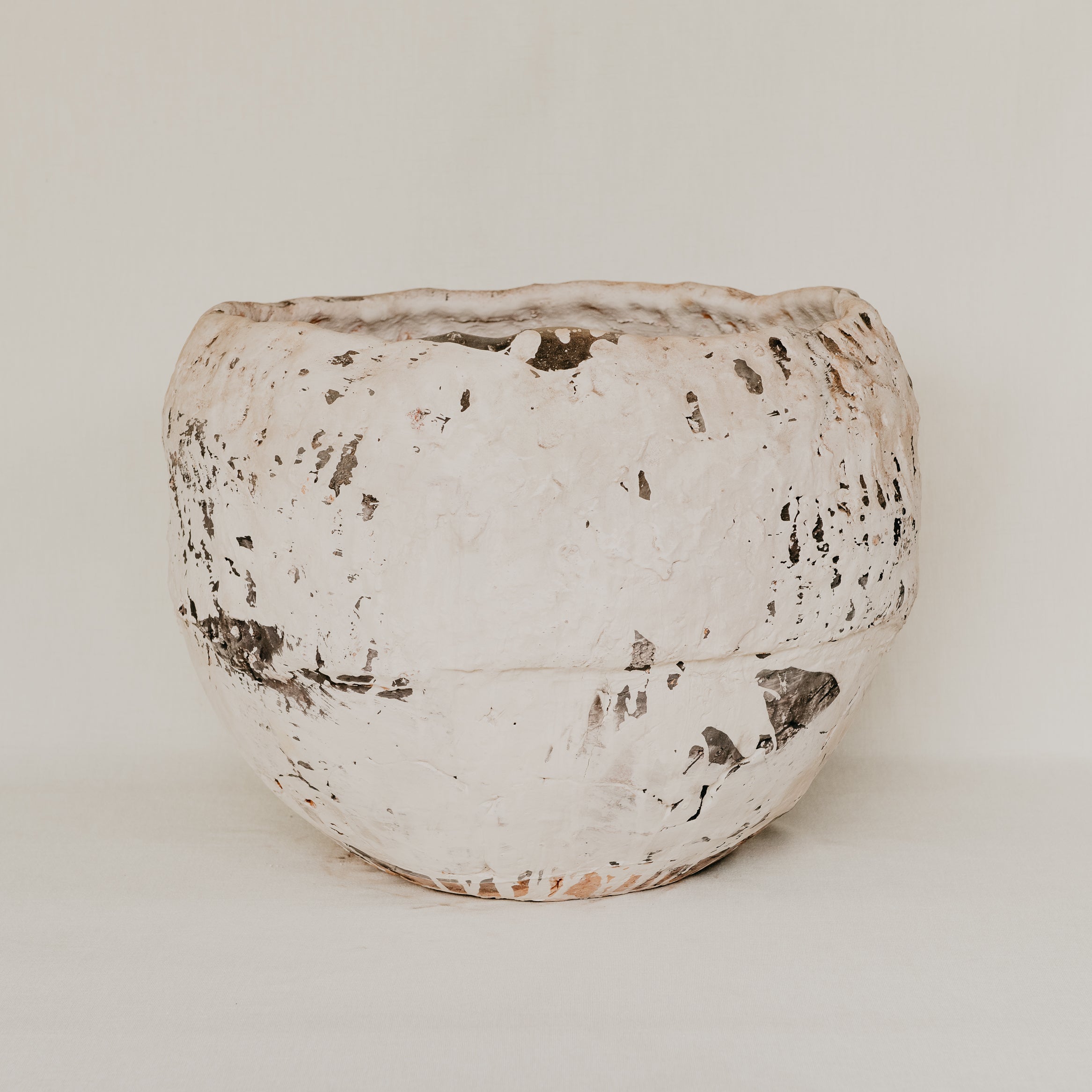 Textured ceramic pot on a white background
