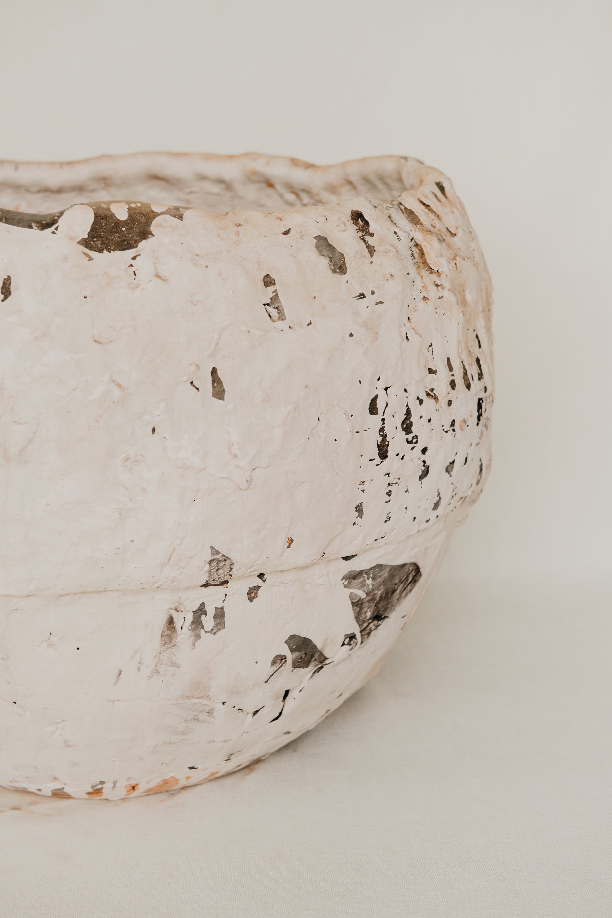 Close-up of a textured ceramic bowl on a light background
