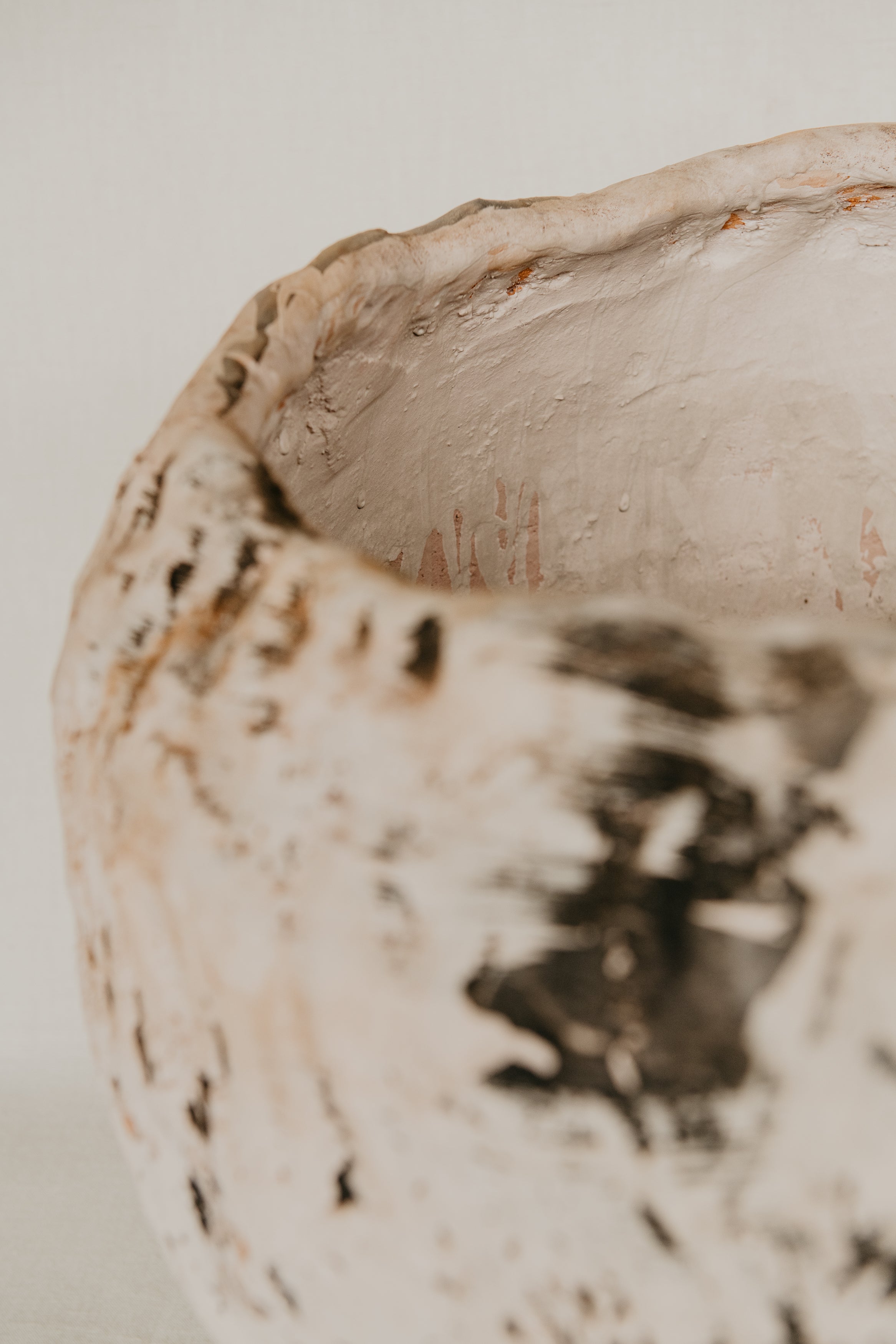 Close-up of a textured ceramic bowl on a neutral background