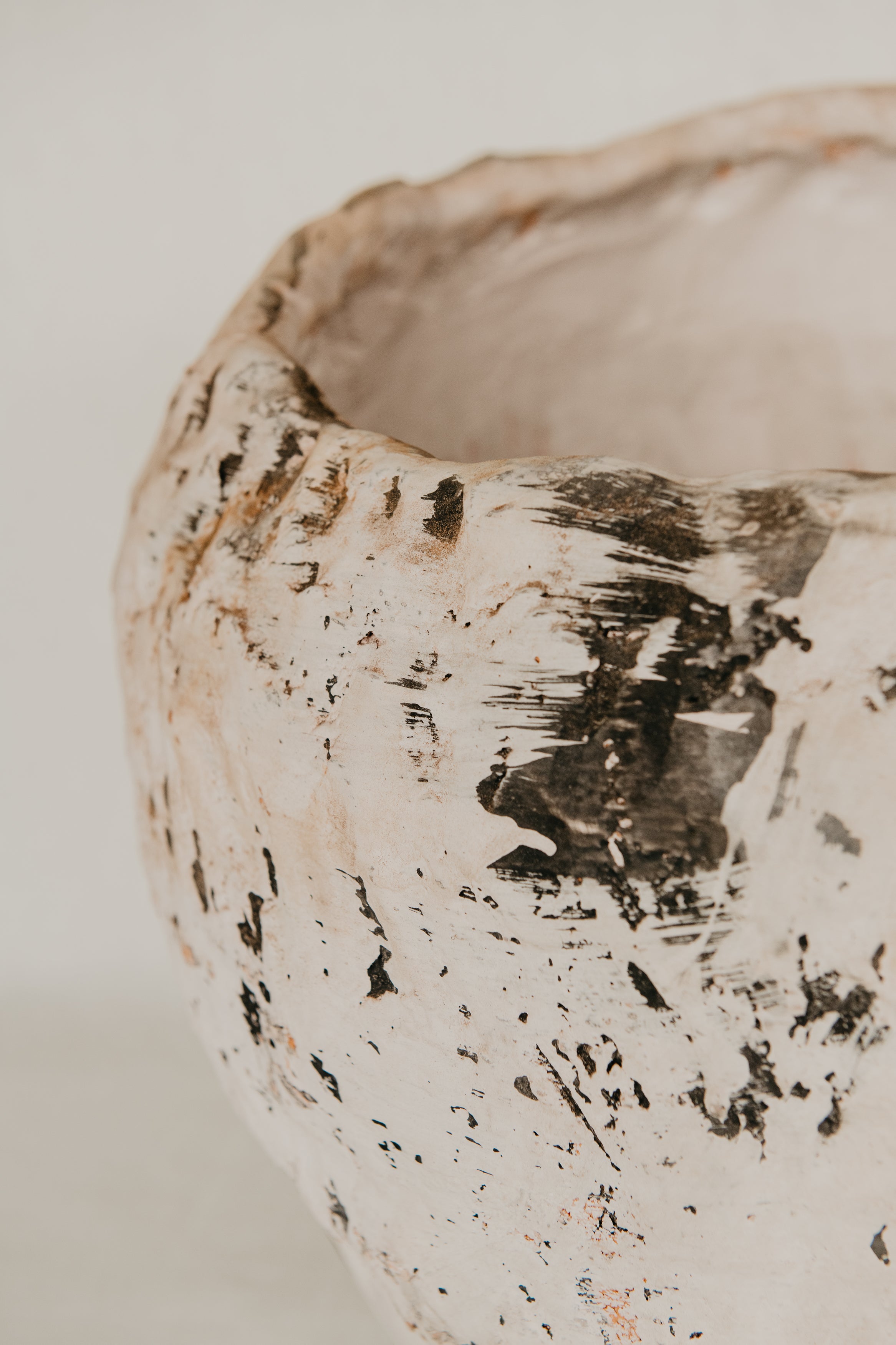 Close-up of a textured ceramic bowl on a light background