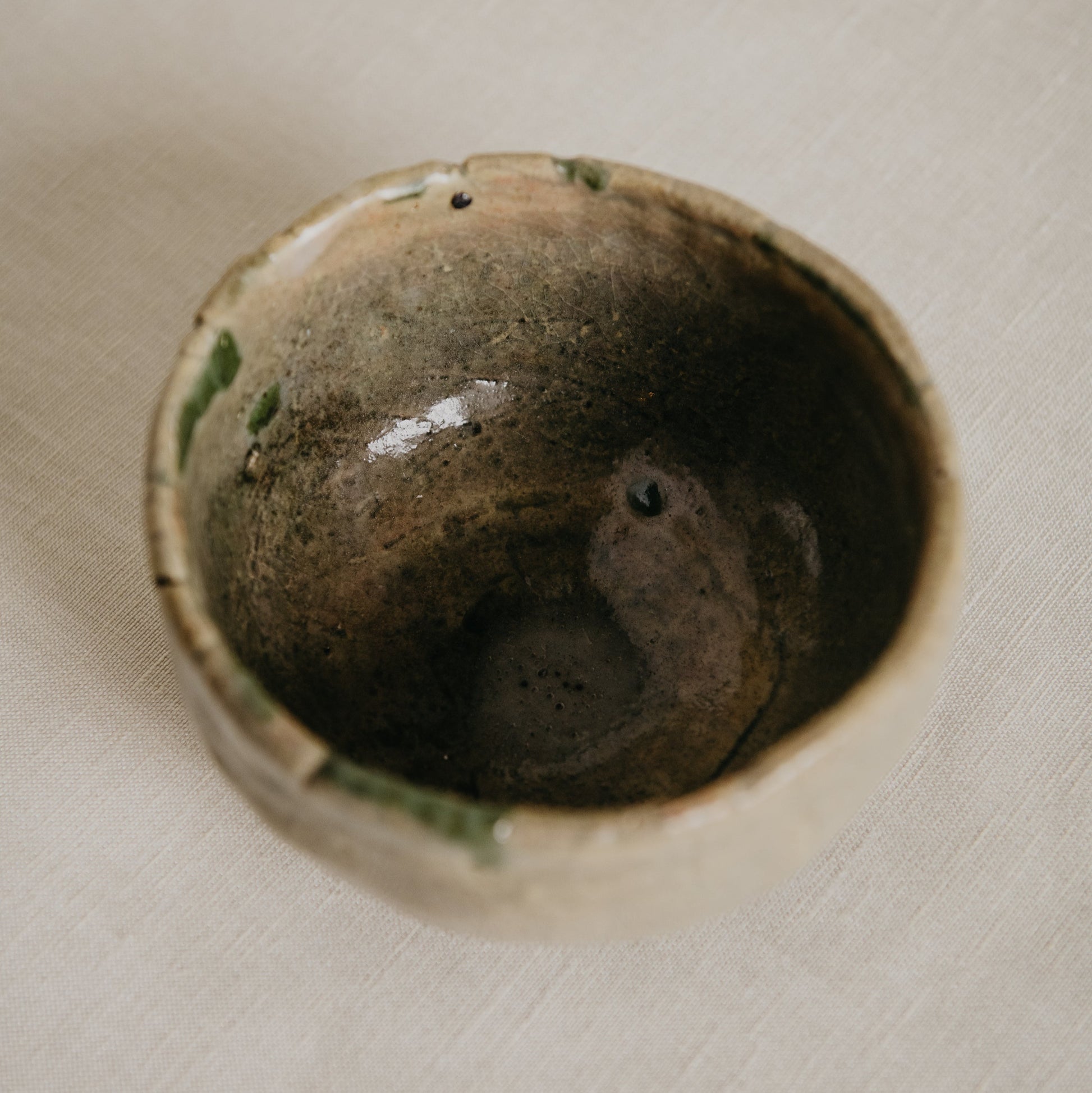 Close-up of a ceramic bowl with a textured surface on a light background