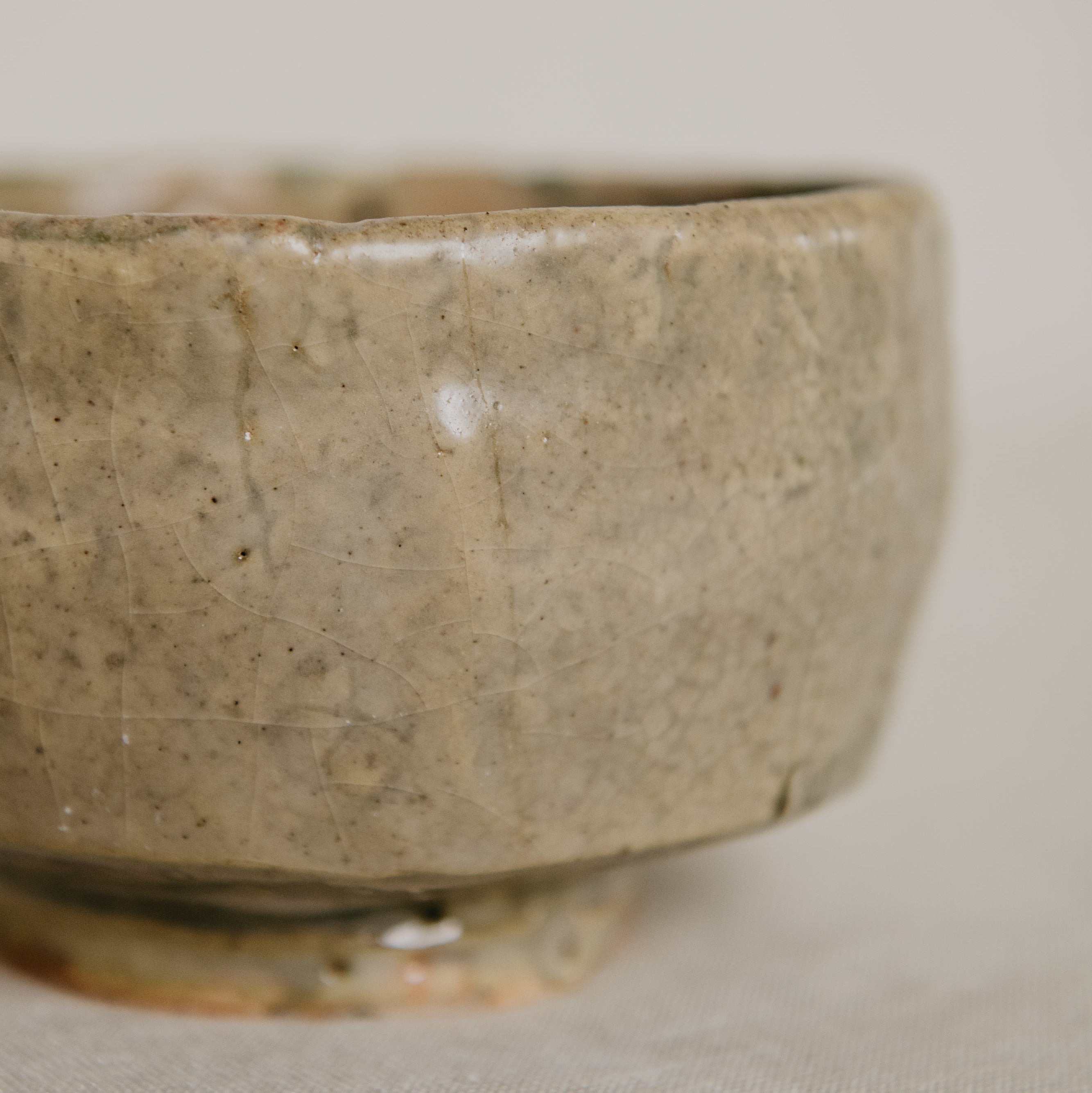 Close-up of a ceramic bowl with a textured surface on a neutral background